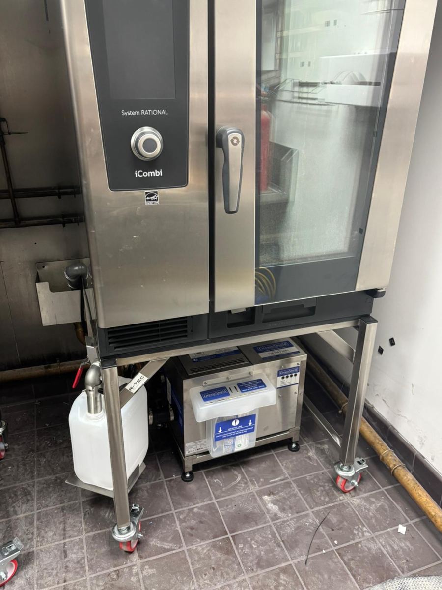 RATIONAL oven installation showing tundish, door, copper drainage pipework, fat drain system and grease trap